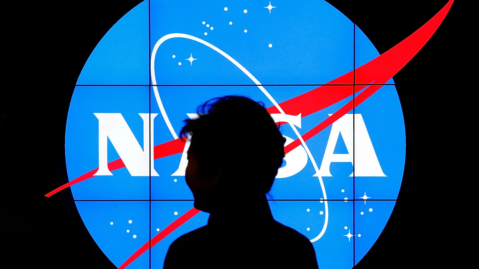 South Korean President Park Geun-hye walks past a NASA logo during a tour of projects and programs that are underway at the agency's Goddard Space Flight Center