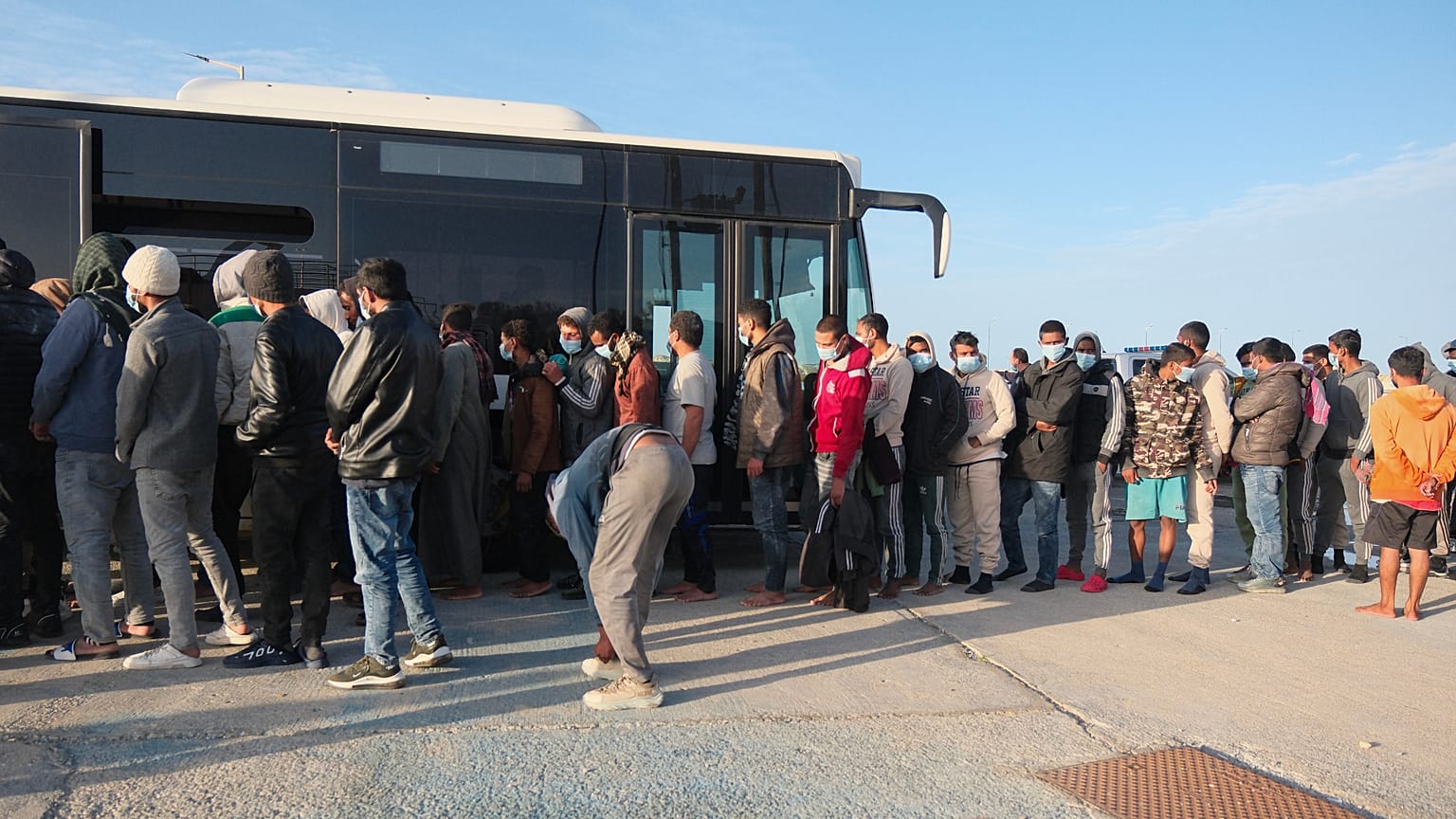 File image - Migrants board a bus at the port of Paleochora, Crete, Sunday 19 October 2025.