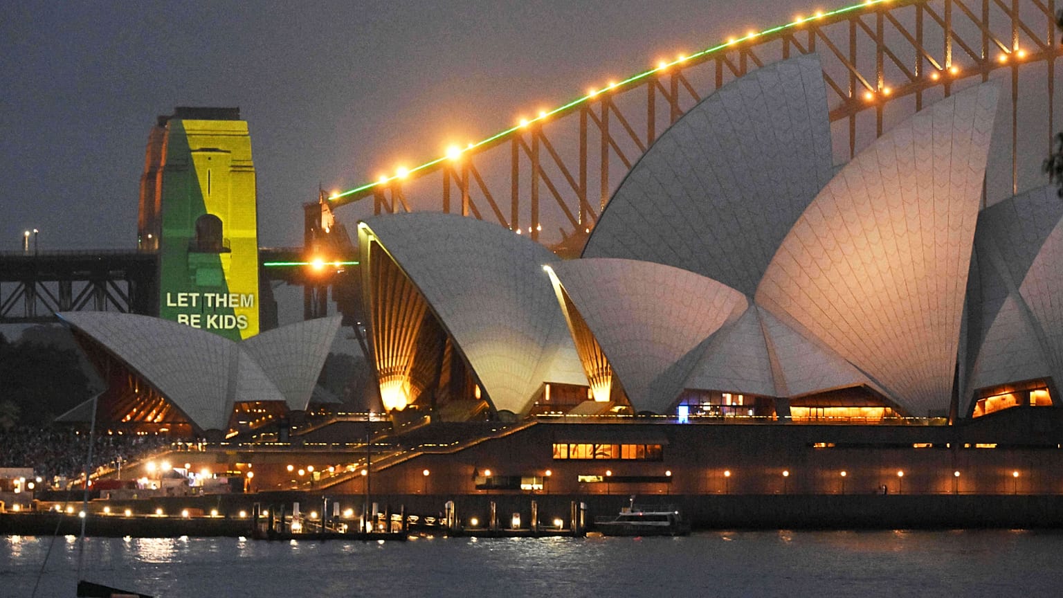 The social media ban for children under 16 slogan "Let Them Be Kids" is projected onto the pylons of the Sydney Harbour Bridge in Sydney.