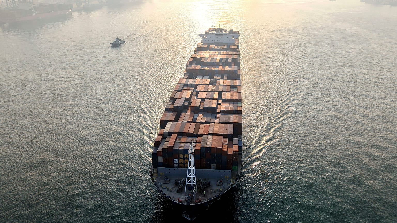 A container ship sails through the harbor in Qingdao in eastern China's Shandong province. 30 Nov 2025.