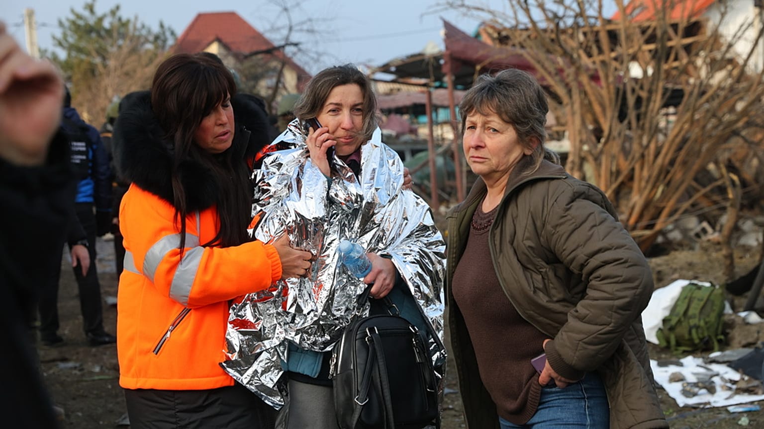 Local residents look at a residential house destroyed after a Russian attack on Zaporizhzhia, Ukraine, Friday, Dec. 19, 2025.