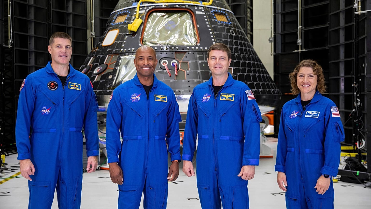 Artemis II crew - Jeremy Hansen, Victor Glover, Reid Wiseman, and Christina Koch - pose in front of an Orion crew module at NASA’s Kennedy Space Center on 8 August 2023.