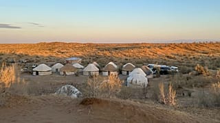 Yurts at a traditional campsite in the desert, where visitors experience nomadic life in Uzbekistan