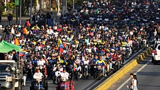 Government supporters ride motorbikes through Caracas, Venezuela