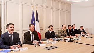 French President Emmanuel Macron, centre, attends a video conference with British Prime Minister Keir Starmer, Thursday, Dec. 11, 2025 at the Elysée Palace in Paris.