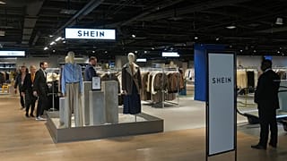 Passers-by inspect the BHV department stores', where fast fashion giant Shein is due to open its first permanent shop in Paris on 5 November 2025.