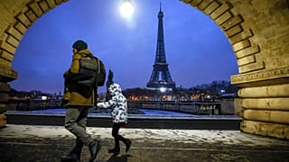 A child goes to school in front of the Eiffel Tower in Paris, 18 January, 2024 