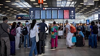 Passengers look a departures information board at Orly airport, near Paris.