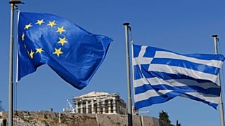 FILE. The Greek, right, and the European flags wave under the ancient Acropolis hill in Athens, 5 July, 2015.