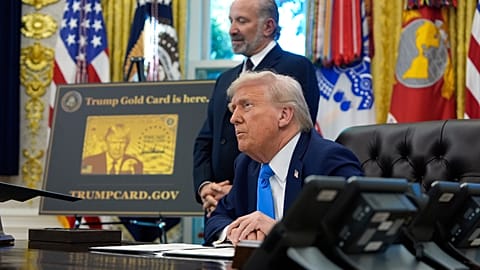 President Donald Trump, seated, and Commerce Secretary Howard Lutnick listen to questions from reporters in the Oval Office of the White House, Friday, Sept. 19, 2025. 